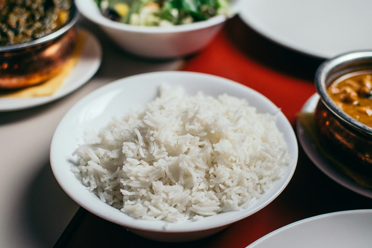 A bowl of white rice with curries