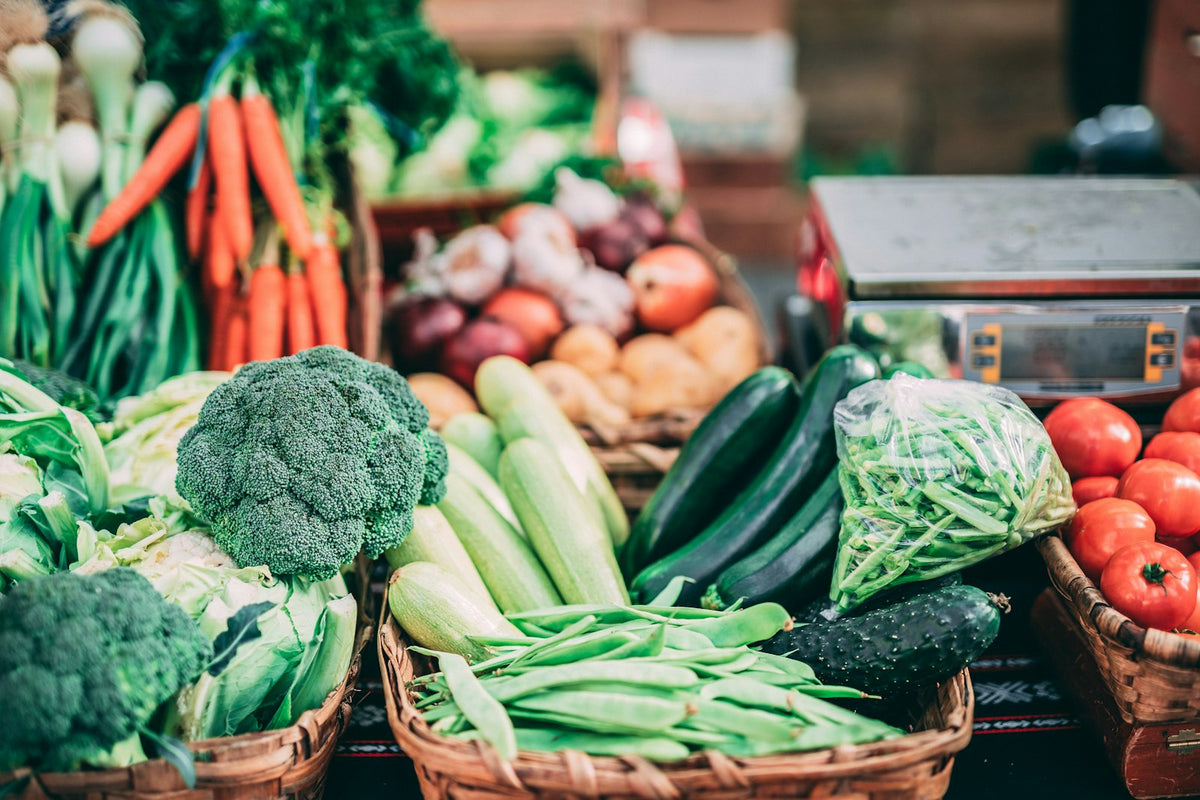 Fresh vegetables piled on a market stall