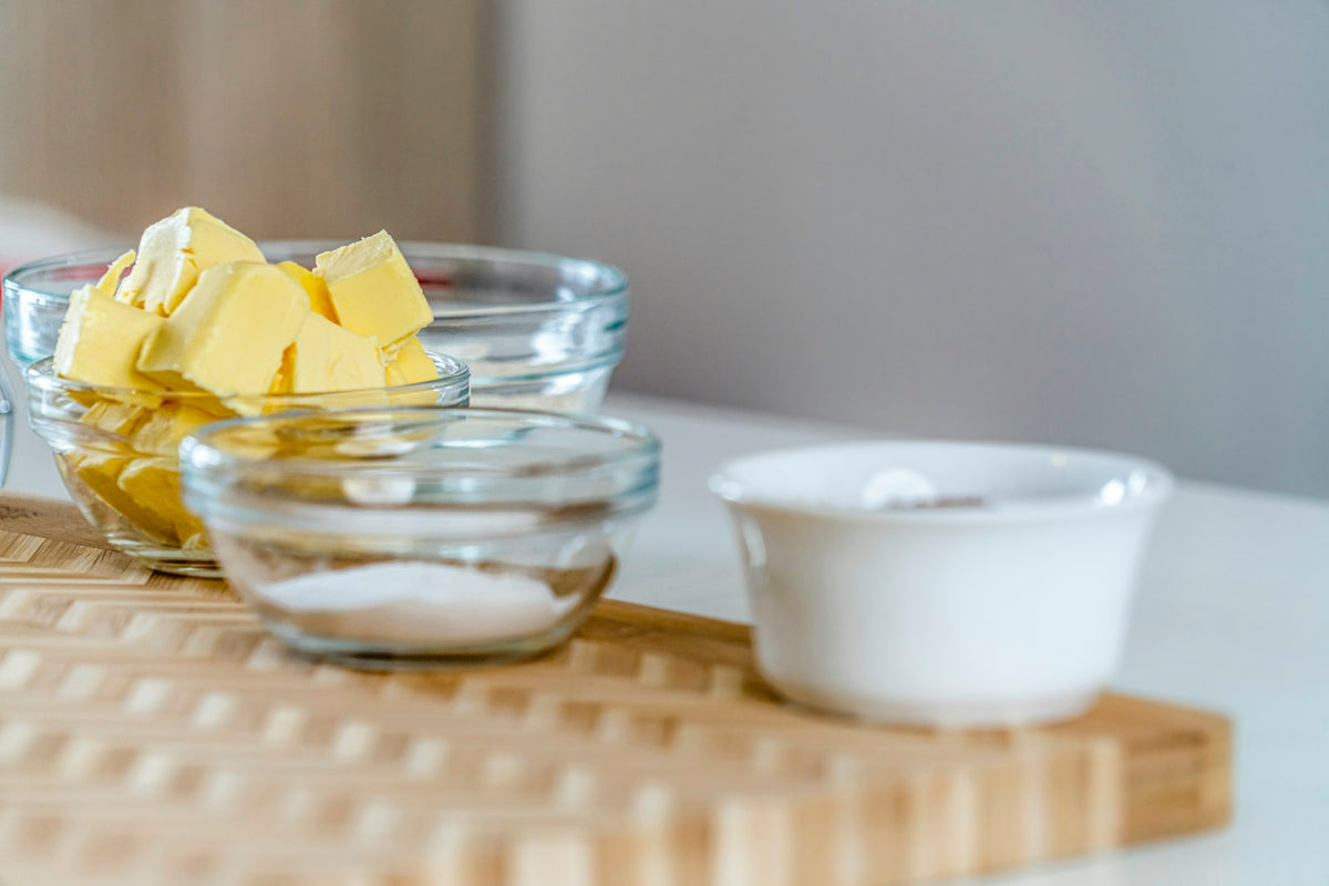 Cubes of butter in a glass bowl on a chopping board