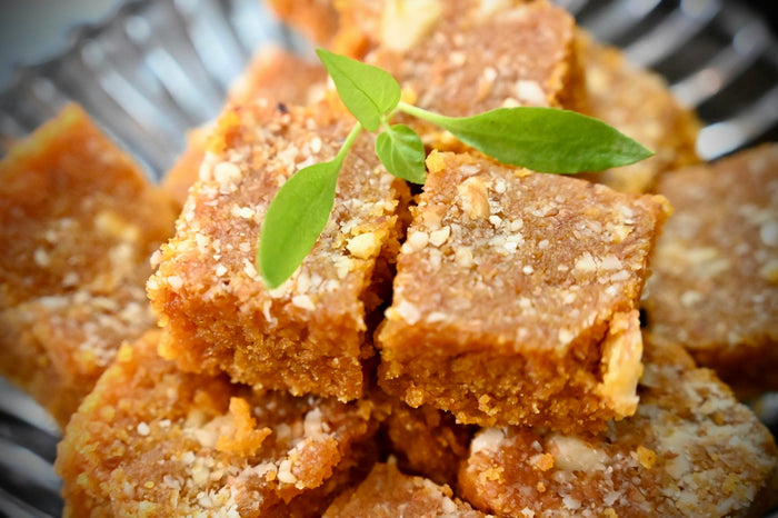 Squares of halwa topped with nuts