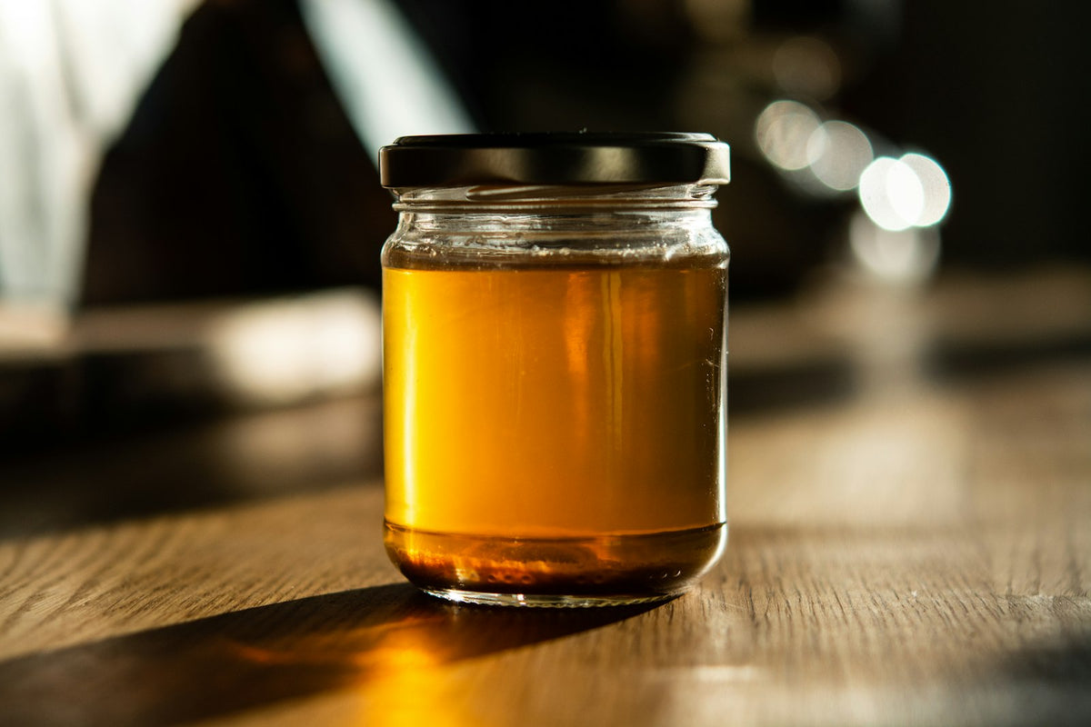 A jar of honey on a wooden table