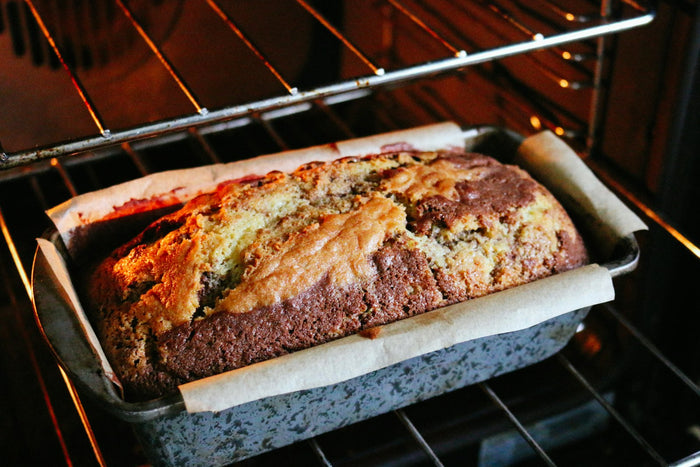 A loaf cake baking in an oven
