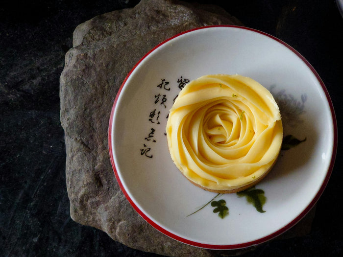 A rose shaped from butter in a bowl