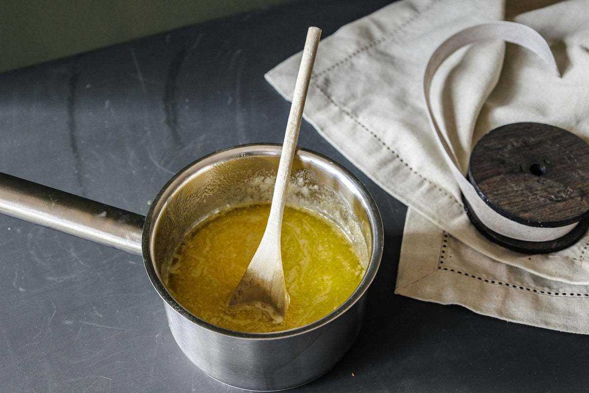 Melted butter in a saucepan with a wooden spoon