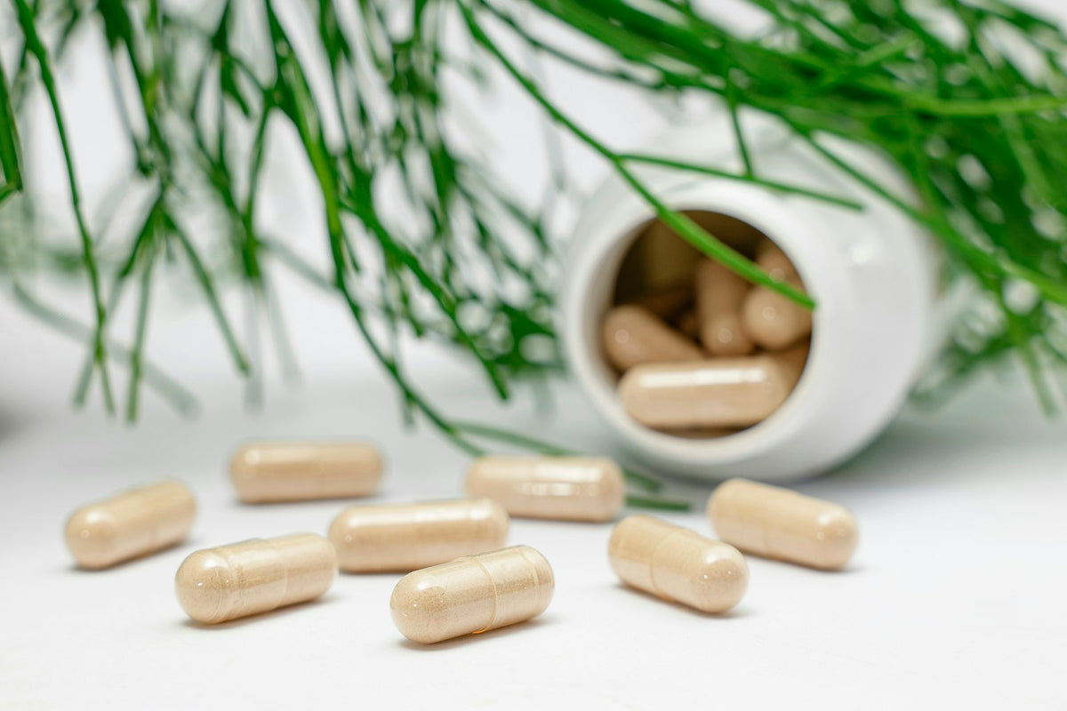 Capsules spilling from a white bottle