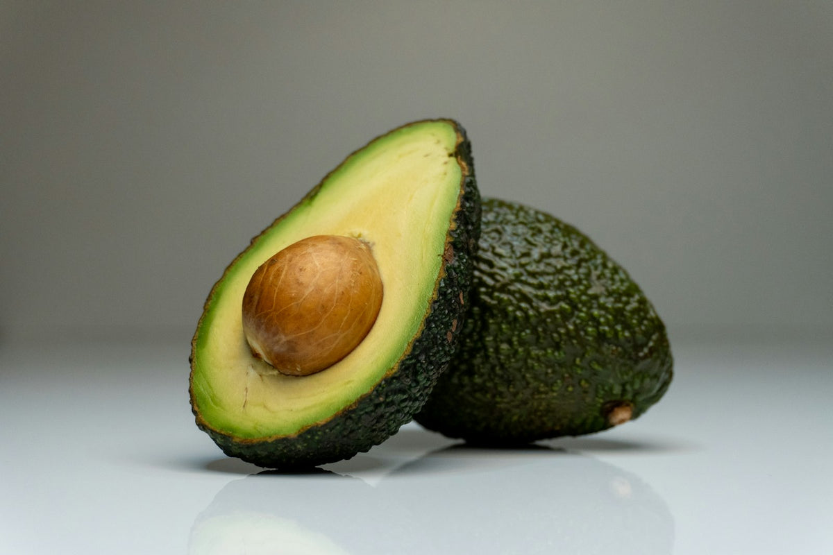 A halved avocado with its stone