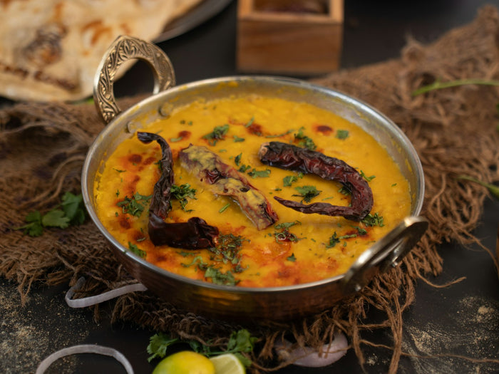 A bowl of dal topped with a dried-chilli tadka