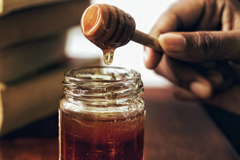 Capped honeycomb being cut by hand