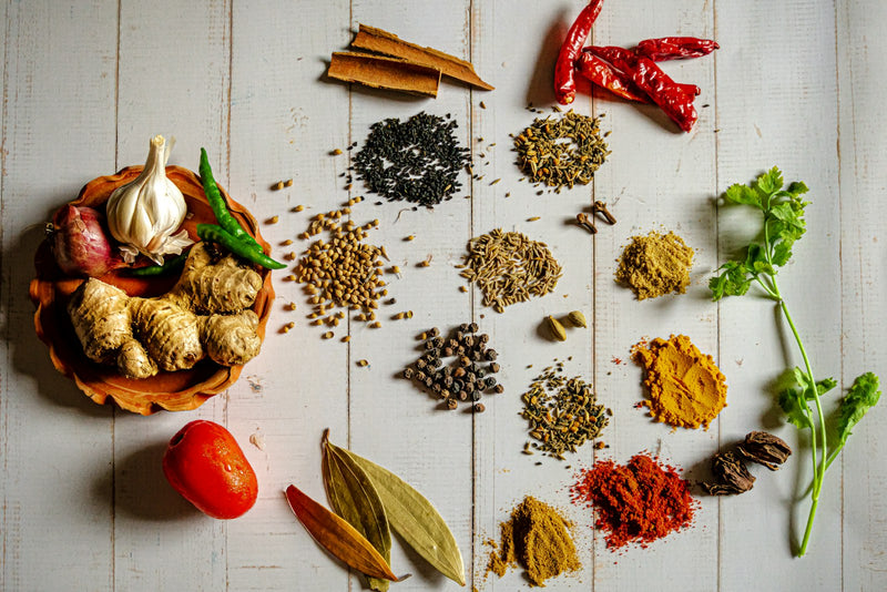 Whole spices drying on cloth in the sun