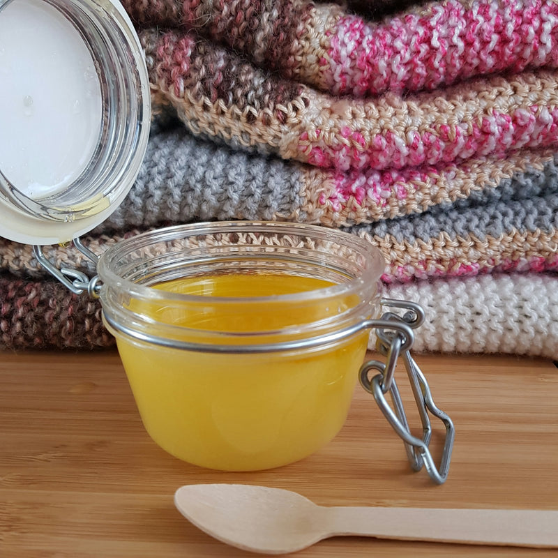 Finished ghee settling in a glass jar