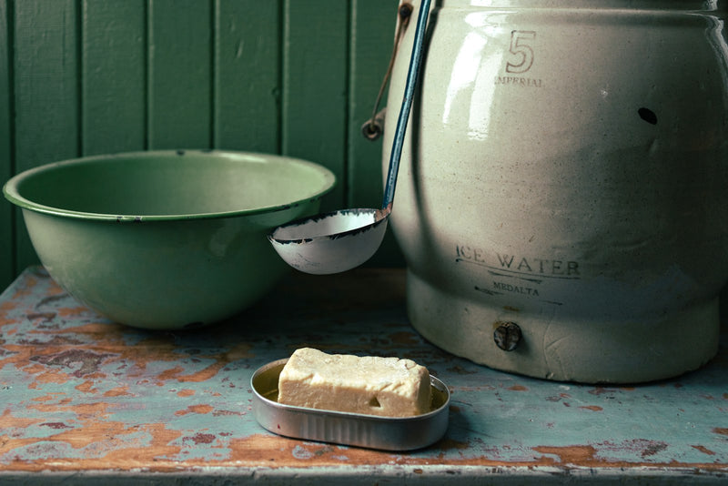 Hand-churning curd with a wooden bilona