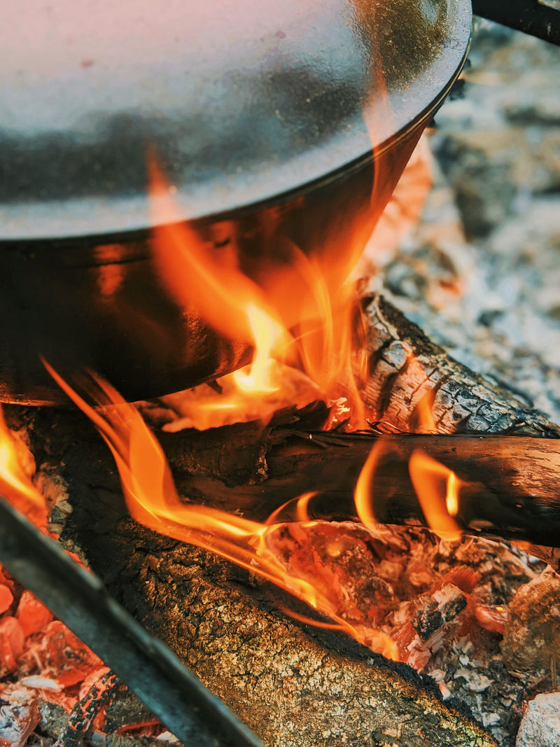 Butter clarifying slowly over a wood fire